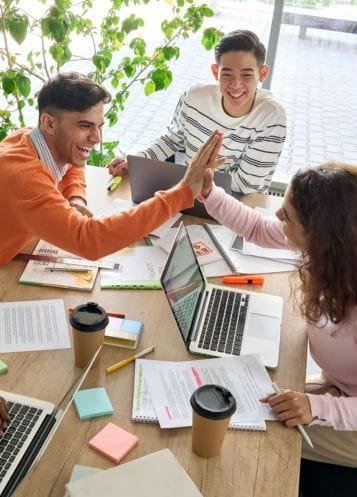 A group of friends laughing and enjoying their time together, showing financial freedom and stress-free money management.